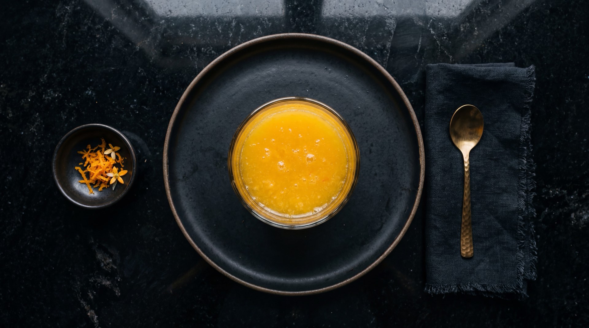 Vaso de jugo de naranja natural exprimido en casa con naranjas frescas cortadas y hielo como alternativa saludable al jugo Hit