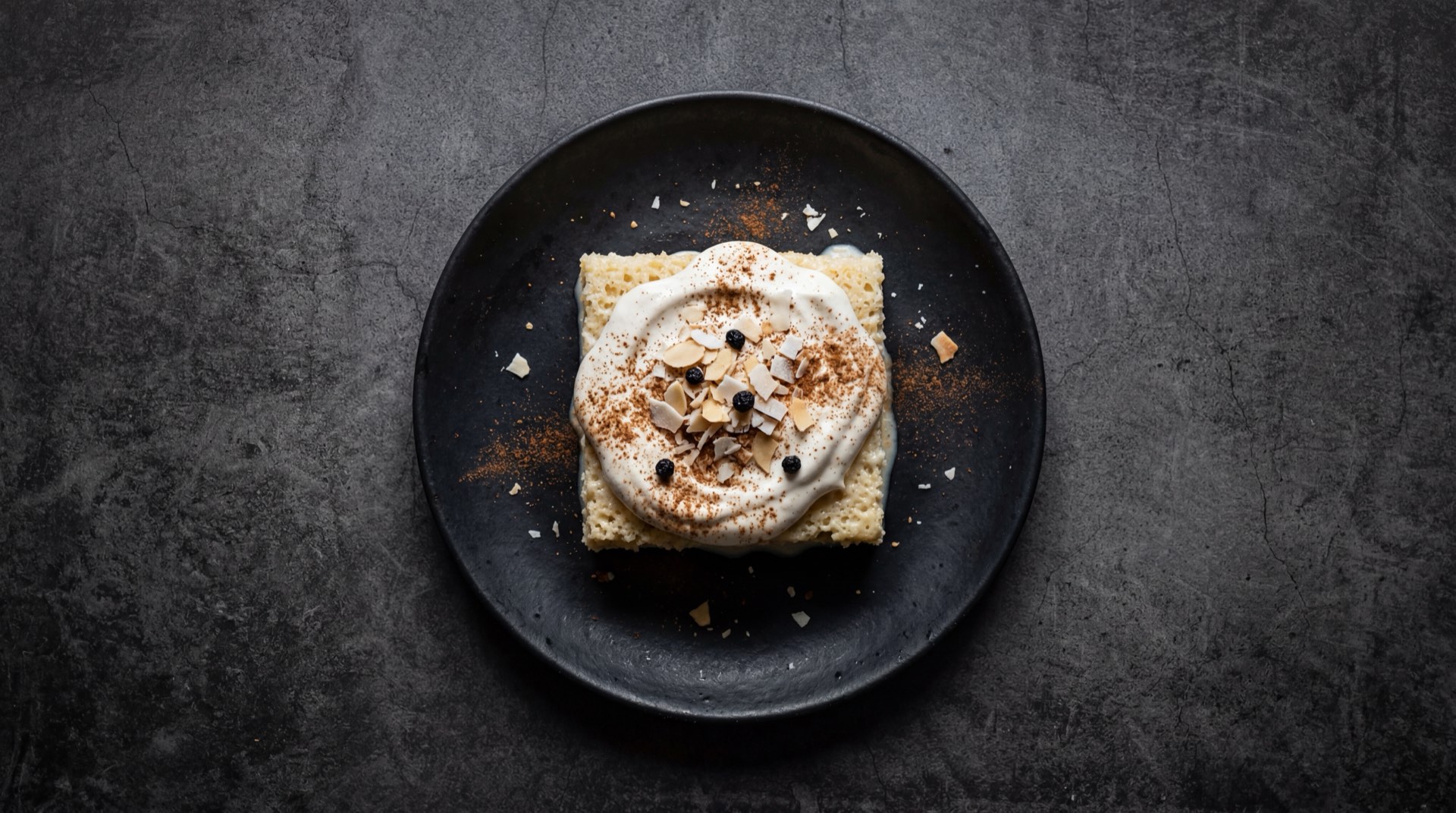 Pastel de tres leches version ligera con leche descremada y menos azucar sobre plato oscuro
